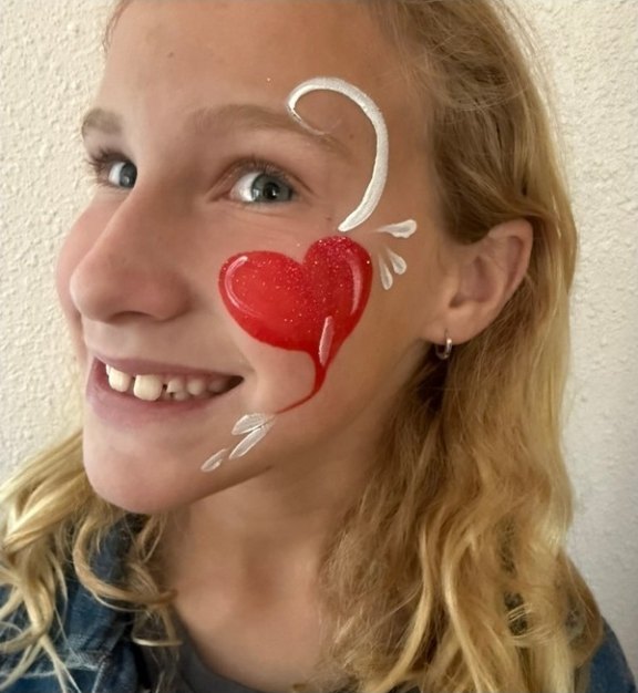 Heart face painting design for winter and holiday events by About Face Painting, Denver