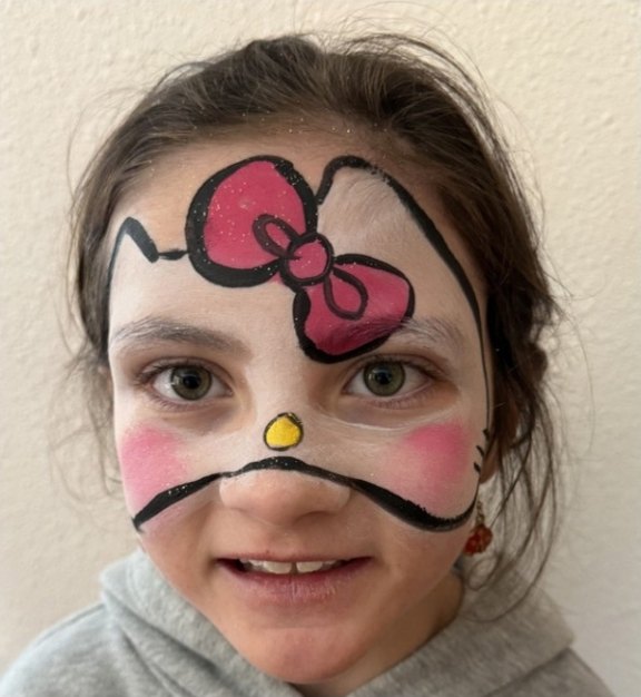 Hello Kitty face painting design for winter and holiday events by About Face Painting, Denver