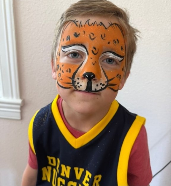 Leopard face painting design for summer events by About Face Painting, Denver