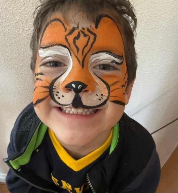 Tiger face painting design for summer events by About Face Painting, Denver