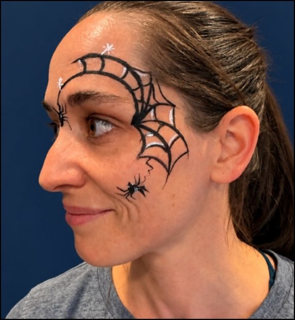 Spiderweb Halloween face painting design by About Face Painting, Denver