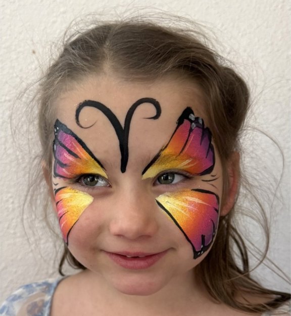 Butterfly face painting design for Easter and spring events by About Face Painting, Denver