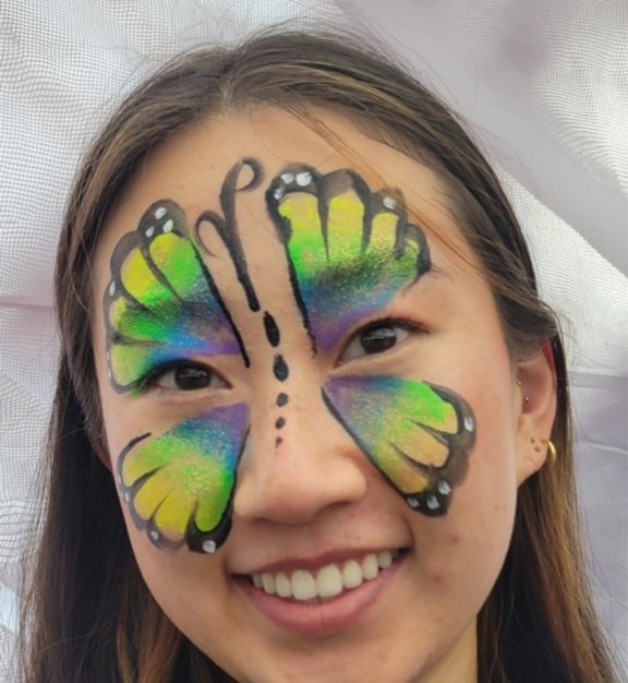 Rainbow Butterfly face painting design for Easter and spring events by About Face Painting, Denver