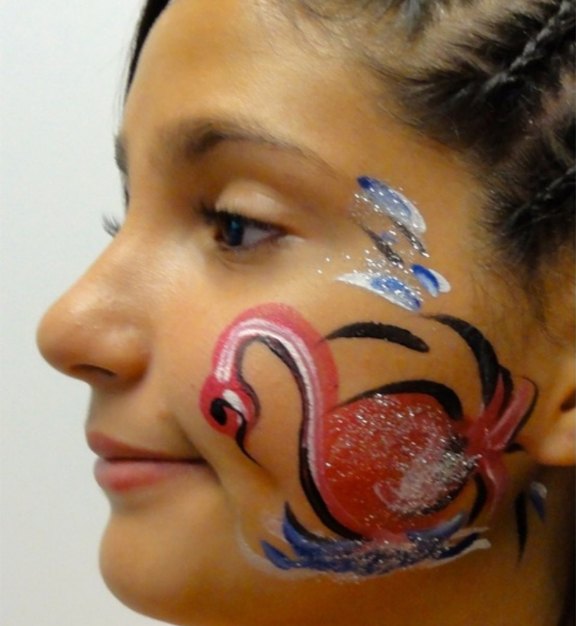 Swan face painting design for Easter and spring events by About Face Painting, Denver