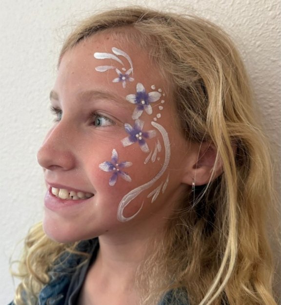 Swirly Flower face painting design for Easter and spring events by About Face Painting, Denver