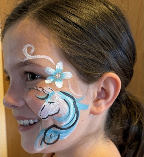Unicorn face painting design for Easter and spring events by About Face Painting, Denver